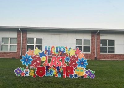 Happy Last Day! in front of school - with tie dye letters, flowers, stars, blue, backpack, school bus, balloons, sunglasses - tropical colors