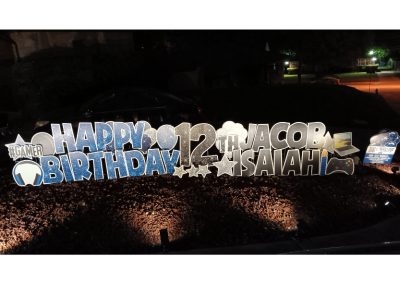 Lawn Sign Letters: Happy 12th Birthday, Jacob Isaiah in Blue and grey sparkles. Lawn Sign Graphics: #GAMER, Star, Headpphones, Game Controller, Laptop, Candle, Balloons - all greys, blues, and bright blues - sparkling