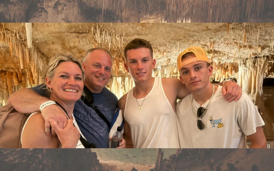 Beth and Doug Mearkle family (Yard Love CT) - 1 man, 1 woman and 2 boys smiling and posing for a photo in a cave