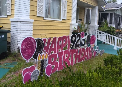 YL Savannah sign - "Happy 92nd Birthday, We Love You!" Pink and black letters, glittery disco theme, candles, balloons