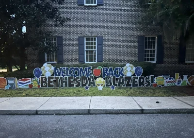 YL Savannah sign - "Welcome Back Bethesda Blazers!" Glittery blue and black letters, school themed symbols, balloons, stars