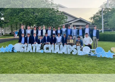 YL Kansas City sign - "State Champs!" A golf team poses with the sign, which has silver letters, is surrounded by golf symbols, "You Did It!", a trophy, blue balloons and stars